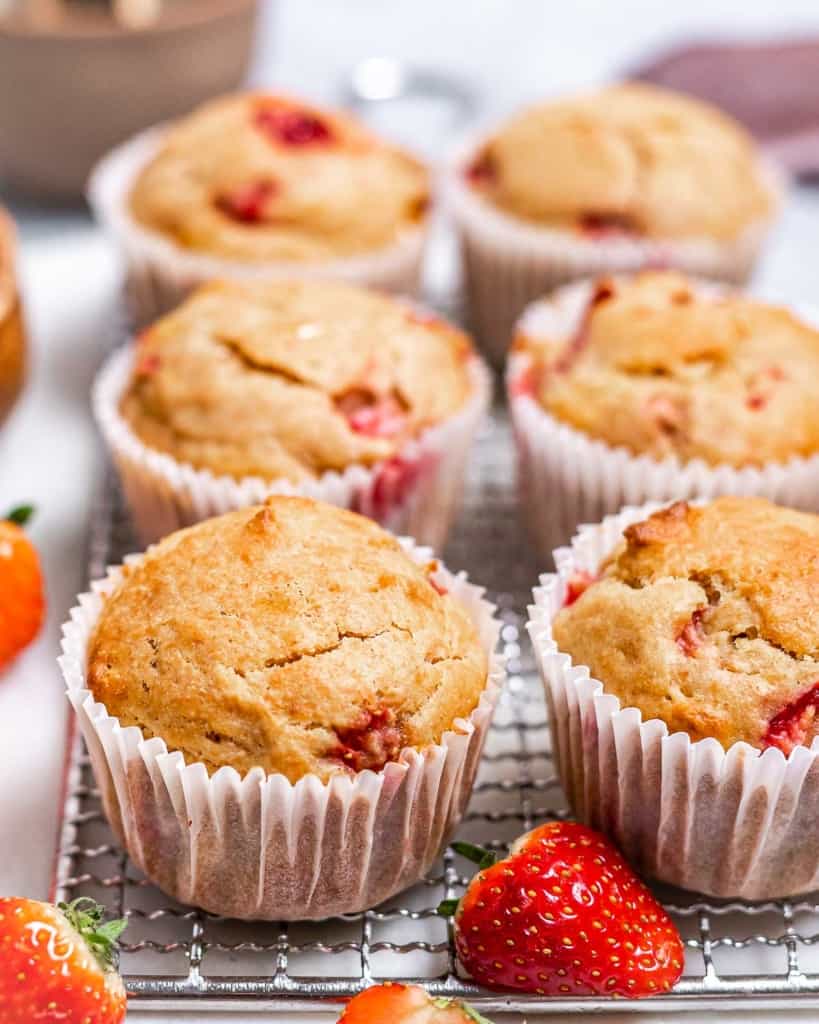 Strawberry muffins on a wire rack.