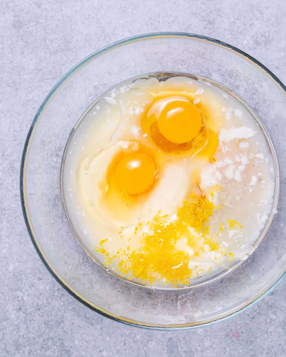 Eggs with yogurt in a mixing bowl.