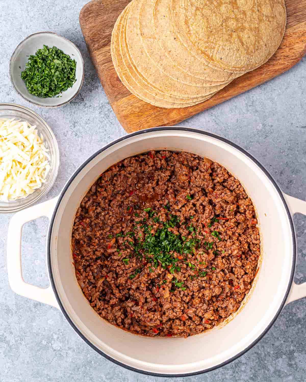 Seasoned ground beef in a pot with cilantro.