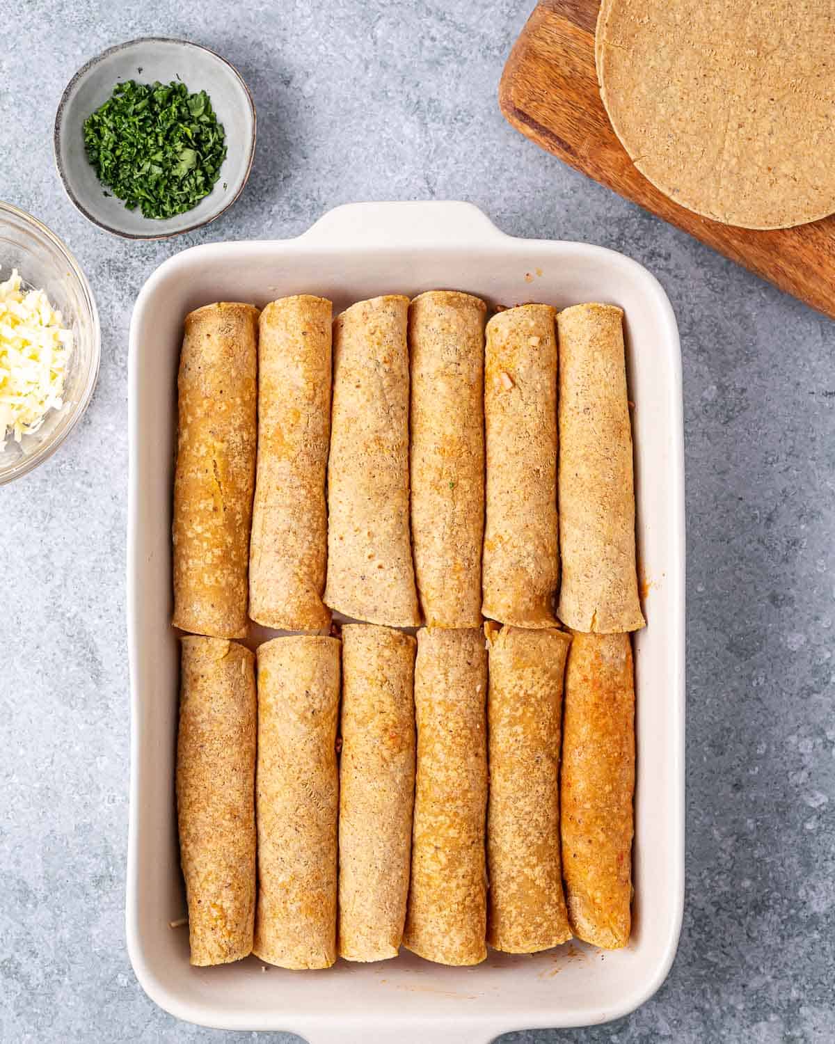 Tortillas rolled and placed in a baking pan.