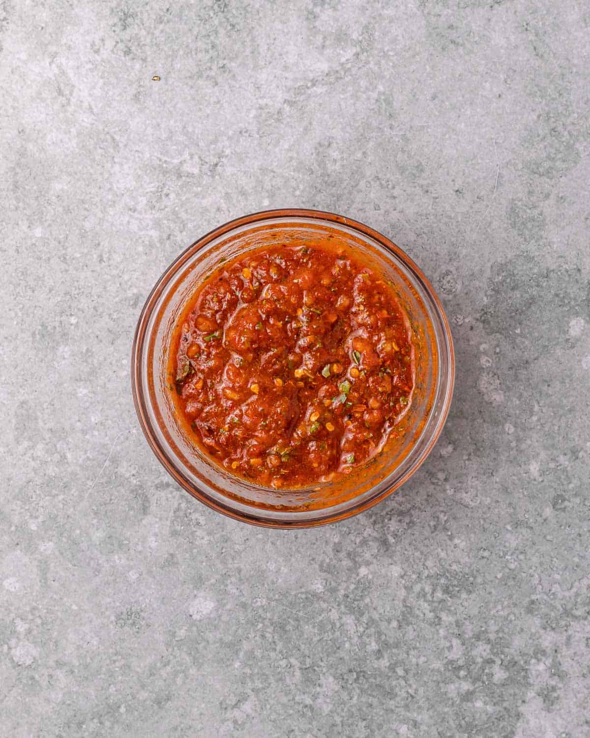 Tomato marinade sauce in a small bowl.