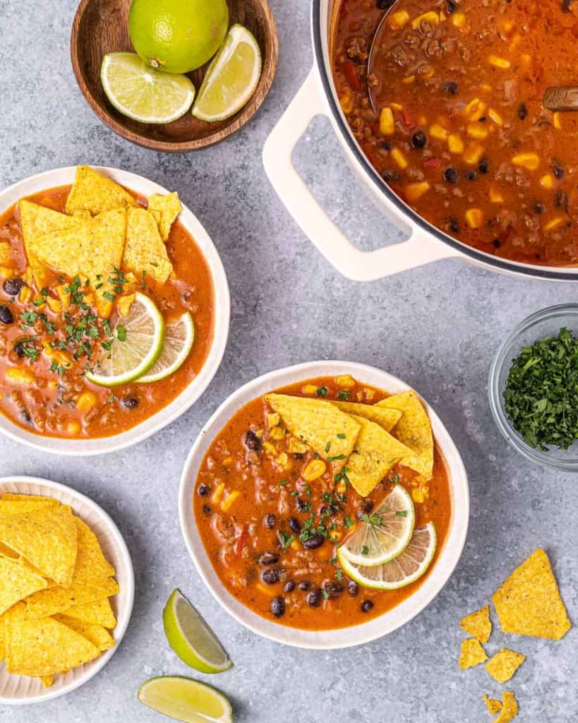 Bowls of soup with beef, black beans and tortilla chips.