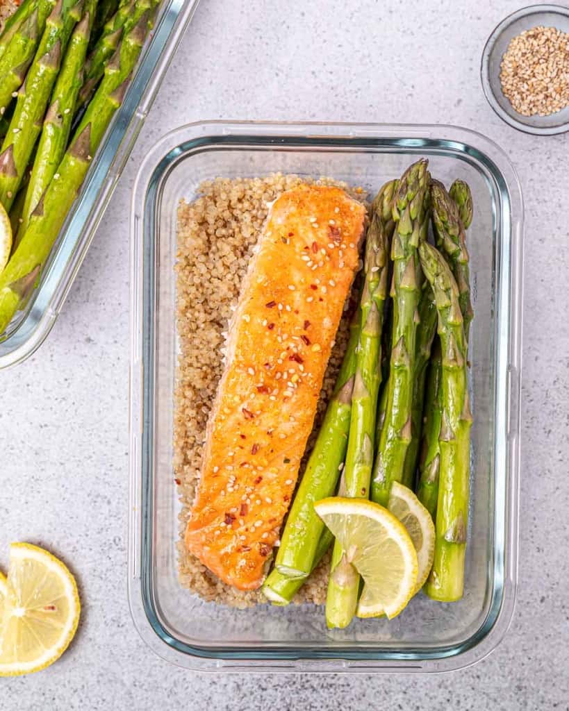top view salmon in a bowl with quinoa and asparagus 