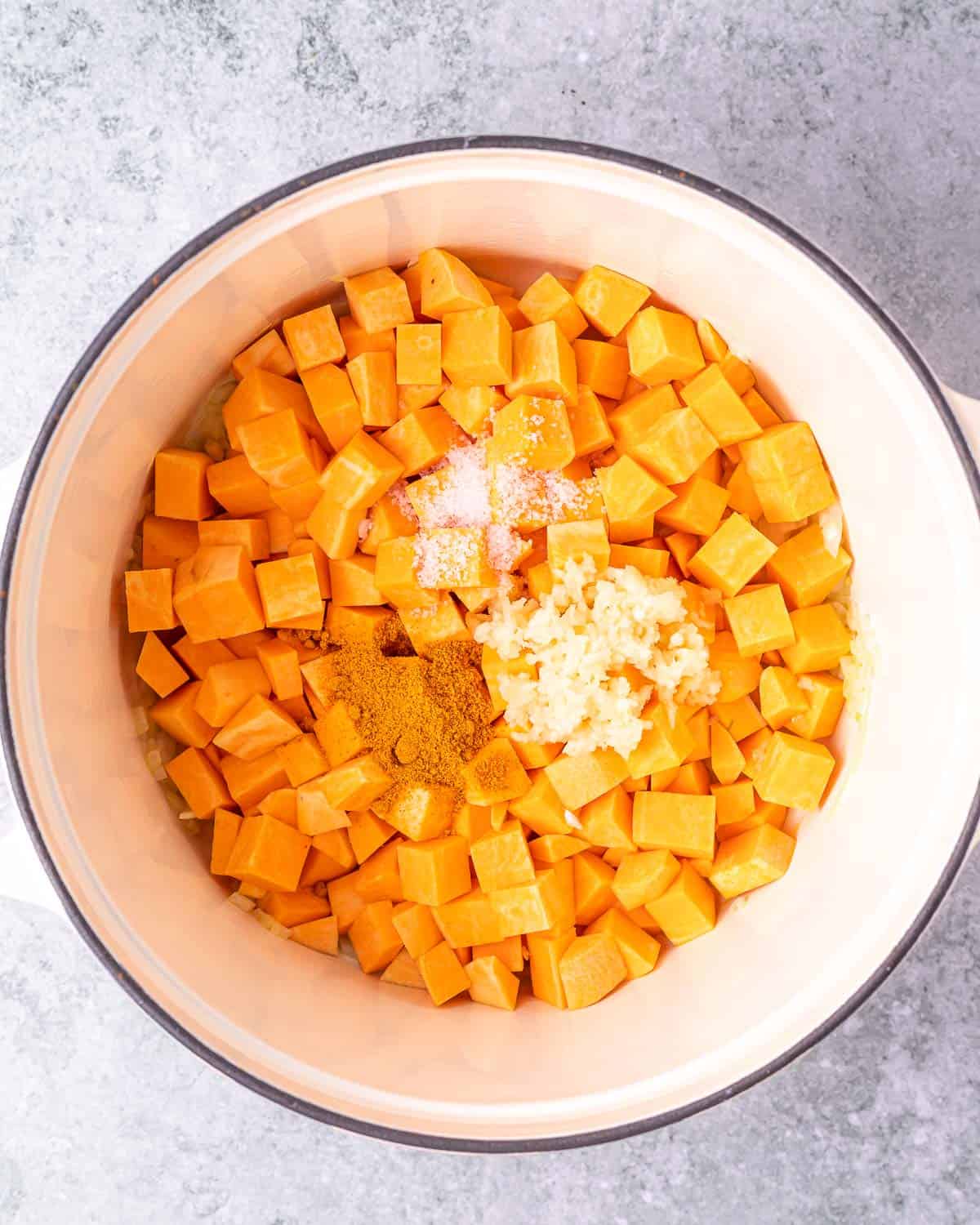 Cooking cubed sweet potato in a dutch oven.
