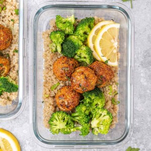 top view of glass bowl with quinoa topped with chicken meatballs and broccoli