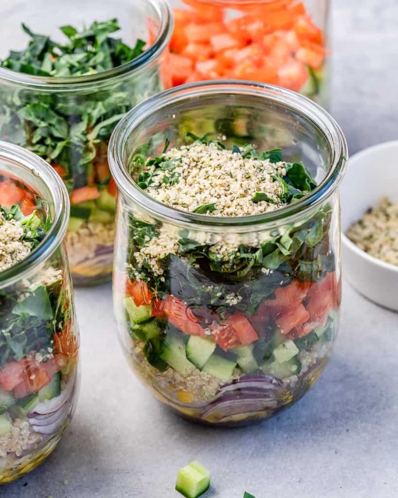 Salad jar made with kale, quinoa and tomatoes.