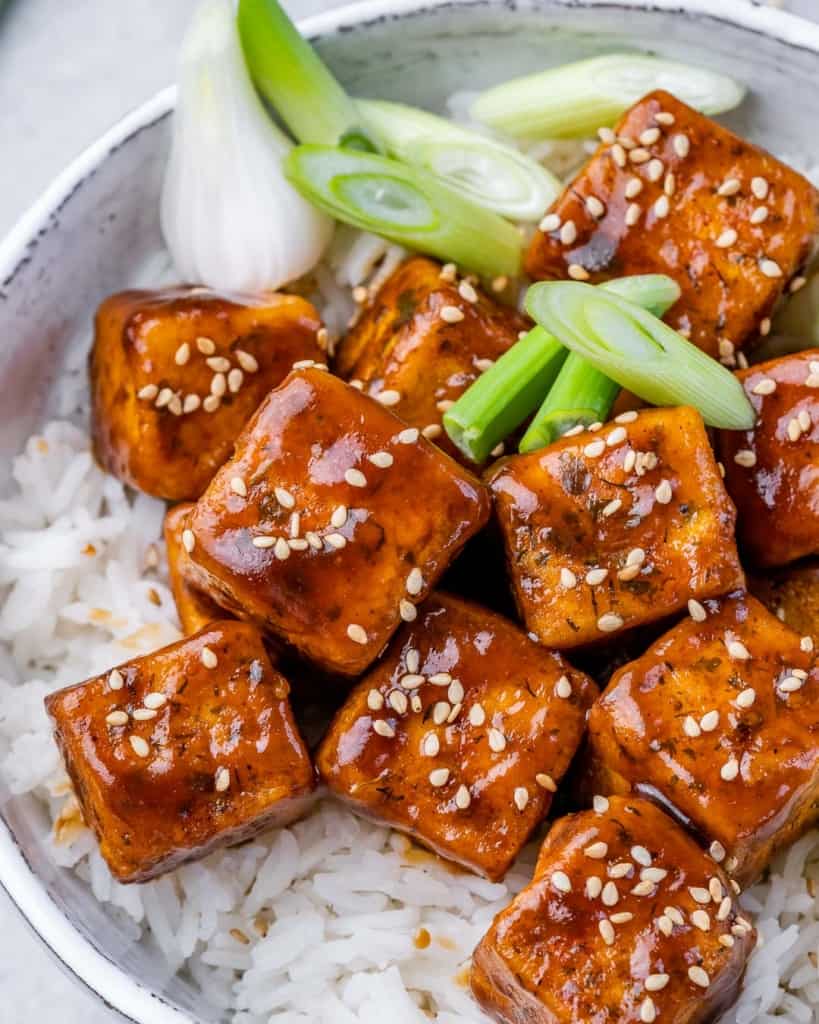 top view honey garlic tofu pieces served over white rice