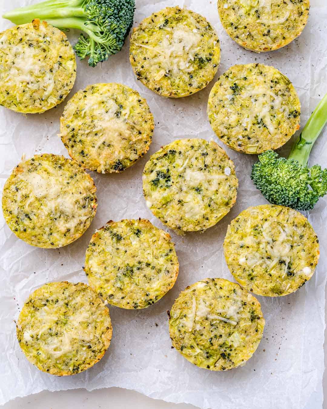 Overhead view of freshly baked broccoli cheddar quinoa bites arranged neatly on parchment paper.