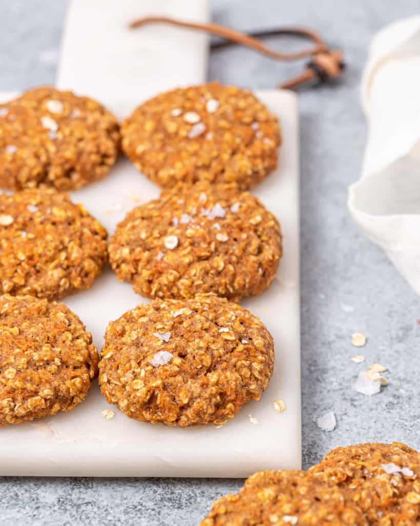 Carrot cake cookies lined up on a cutting board.