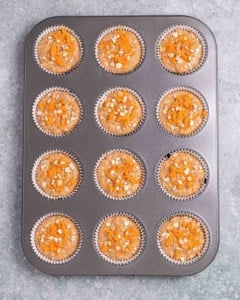 Muffin batter in a muffin pan.