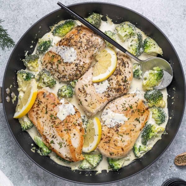 top view of seared chicken breast with a creamy dill sauce and broccoli