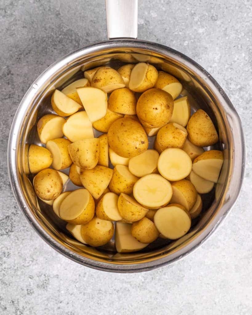 cooked halved potatoes in a pot