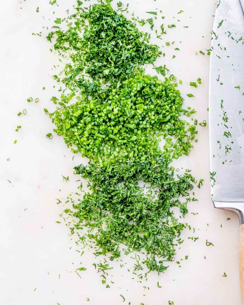Chopping fresh herbs with a knife.