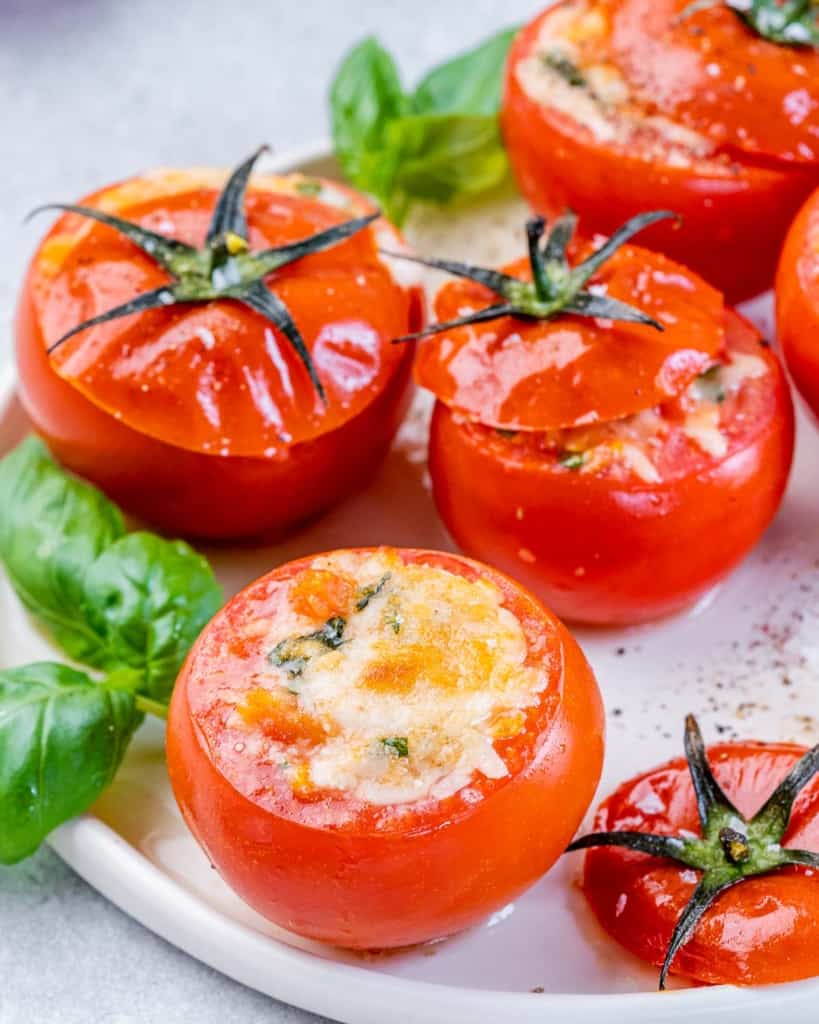 Tomatoes stuffed with cheese on a plate.