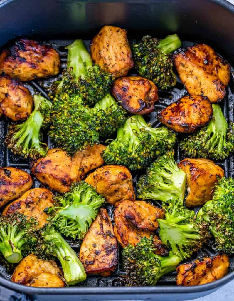 Cooking chicken and broccoli in an air fryer.