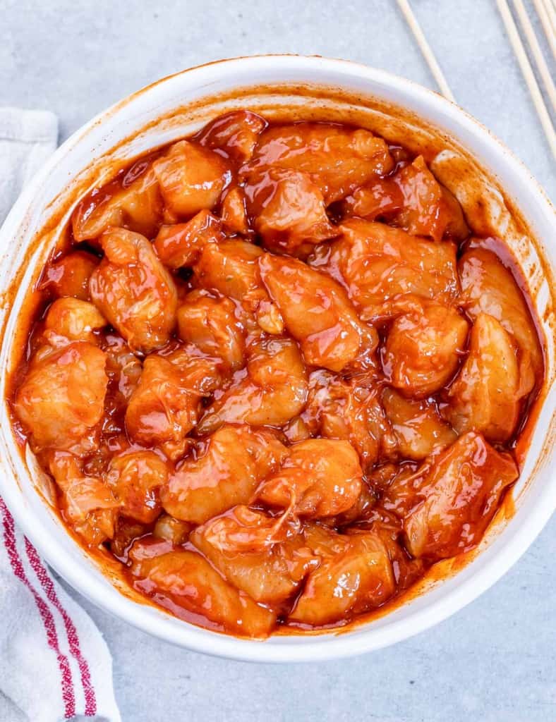 marinated chicken chunks with bbq sauce in a white bowl
