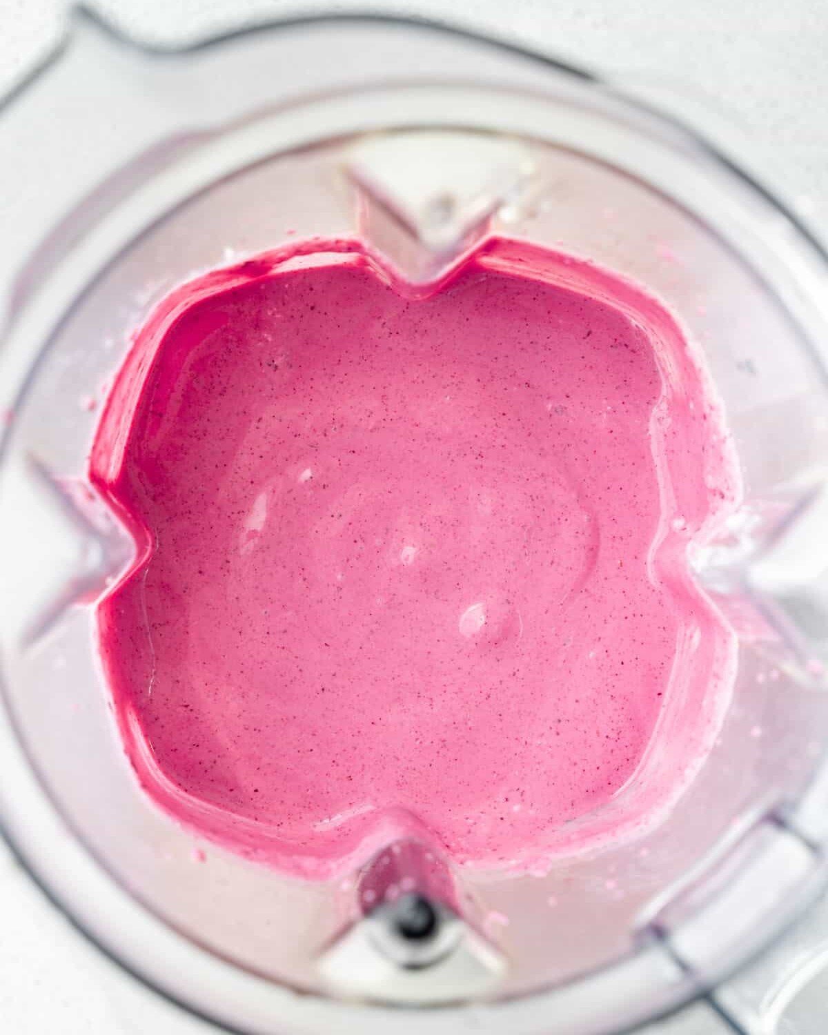 Berries mixed with cottage cheese blended in a blender.