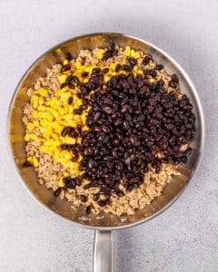 beans and corn added over the sauteed ground chicken