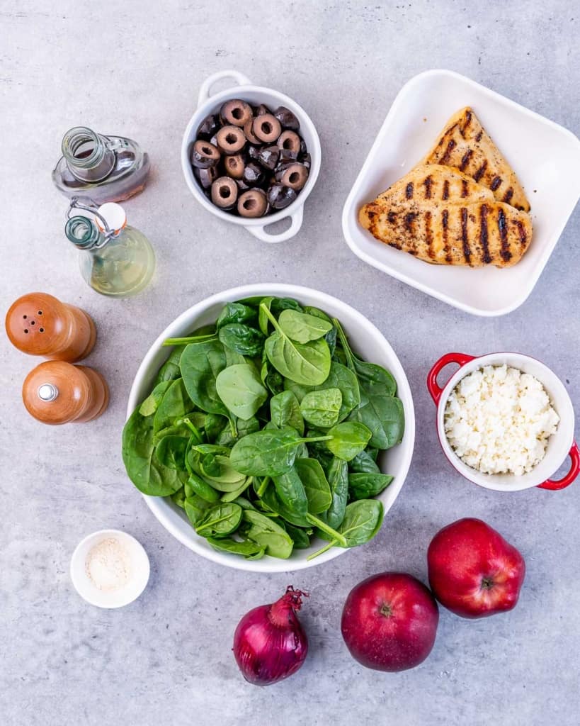 ingredients laid out to make spinach and grilled chicken salad 