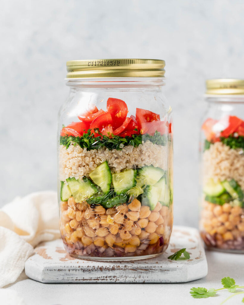 Side shot of quinoa and chickpea salad in a mason jar.