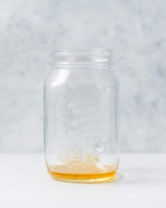 Adding dressing to a mason jar.