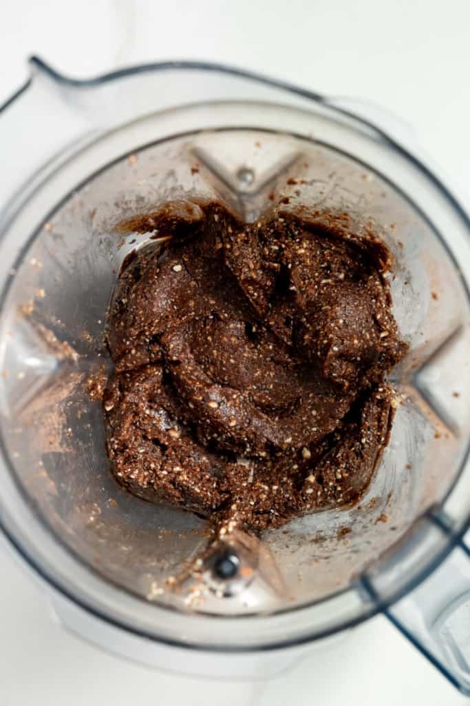Blended dates, nuts and cocoa powder in a blender.