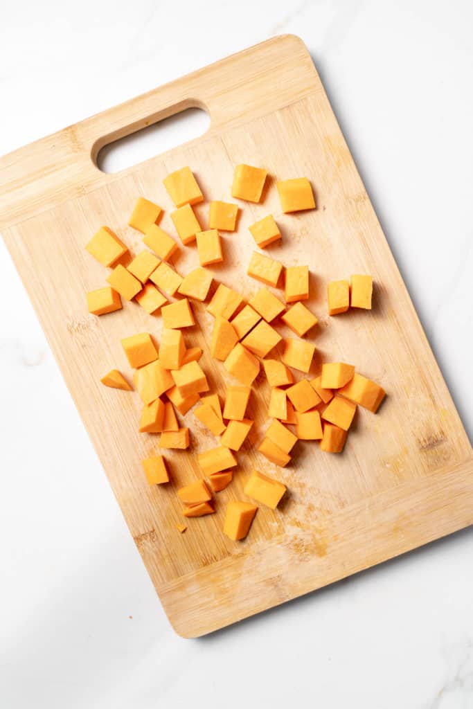 Cubes of sweet potato on a cutting board.