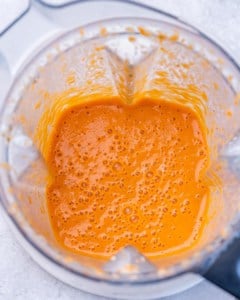 Blended roasted red pepper sauce in a blender, smooth and creamy in texture.
