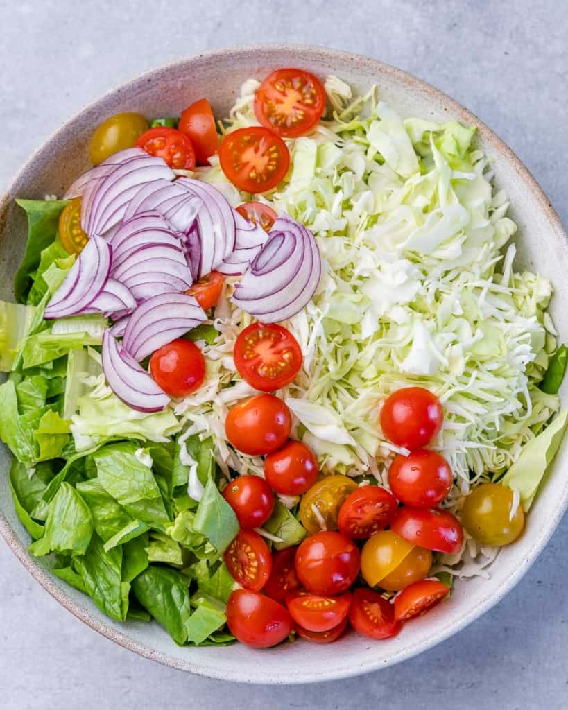 sliced tomato, sliced onion, added over a bed of shredded cabbage and chopped lettuce