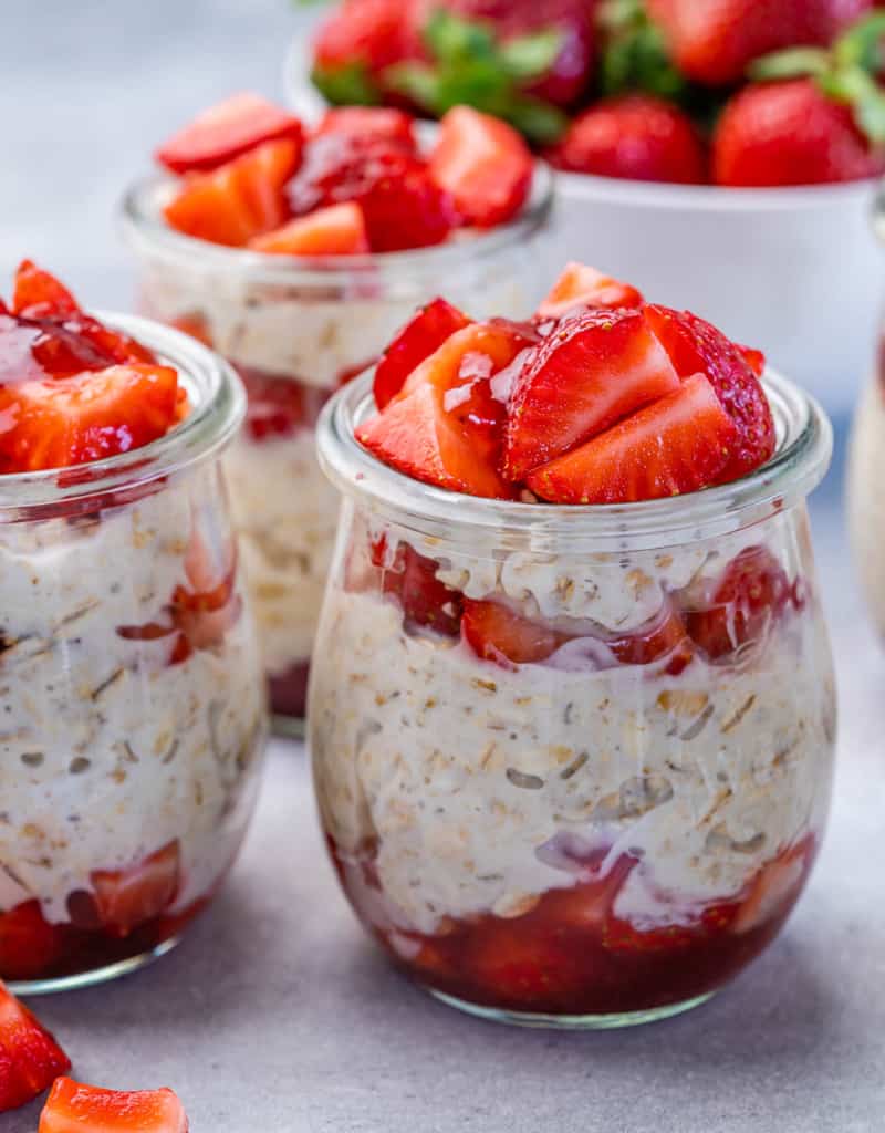 Strawberry cheesecake overnight oats in a glass jar.