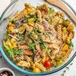 a bowl with pasta salad made with chicken and veggies.