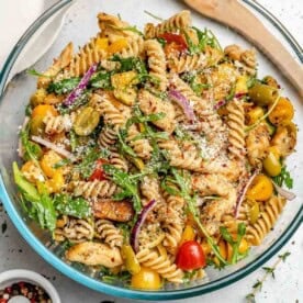 a bowl with pasta salad made with chicken and veggies.