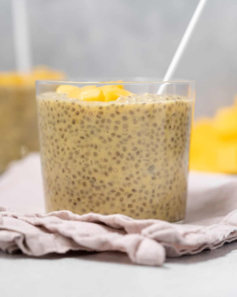 side shot of a clear cup filled with chia seed pudding made with mango and coconut milk