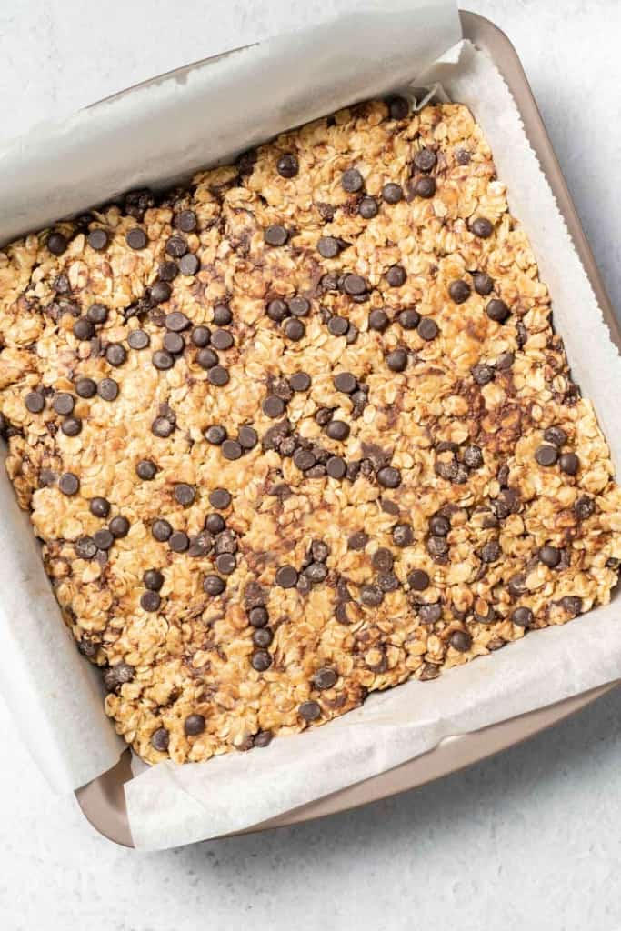 Peanut butter oatmeal bars in a parchment lined pan.