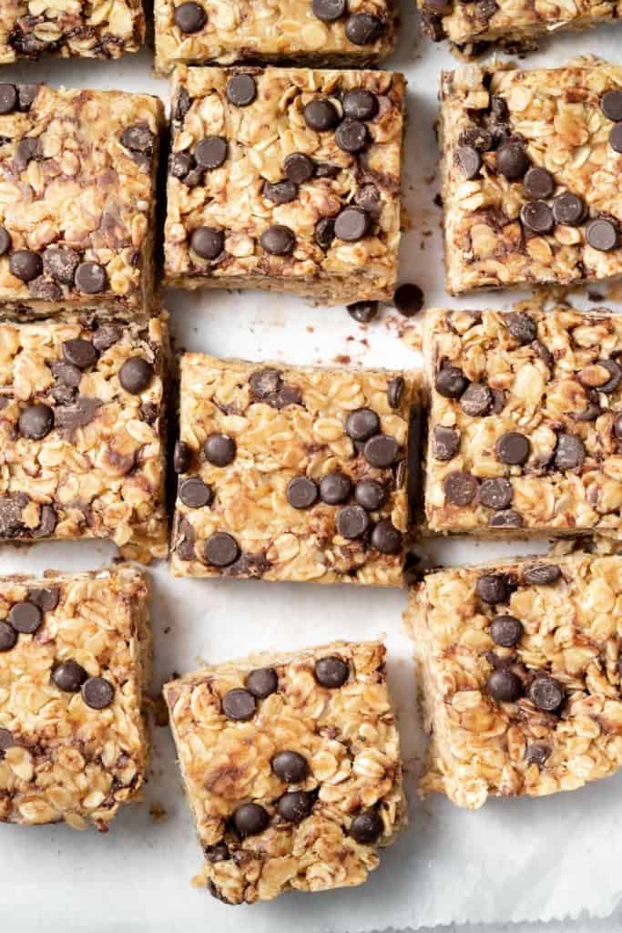 close up view of oatmeal bars that are square in shape with chocolate chips 
