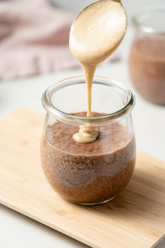 Drizzling peanut butter over chia pudding.