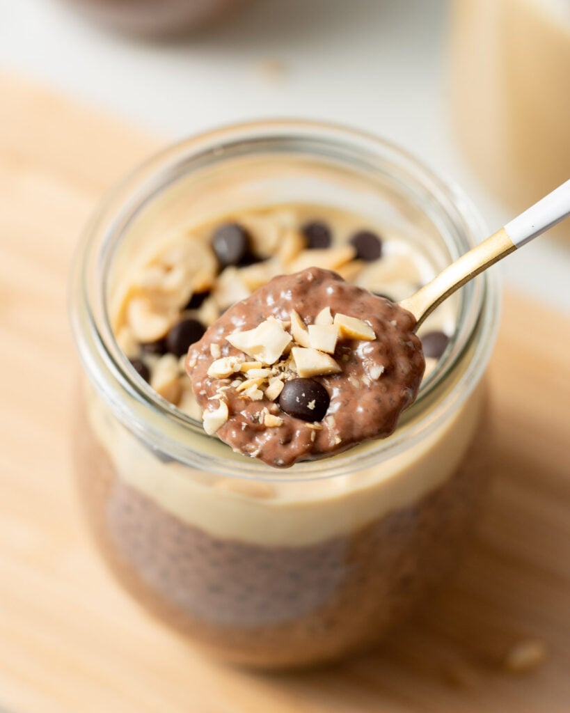 Spoon dishing out peanut butter chocolate chia pudding.
