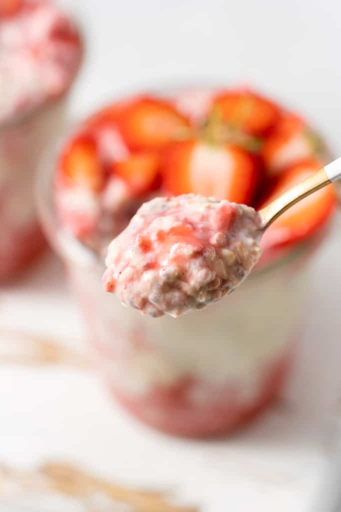 Spoonful of strawberry overnight oats.