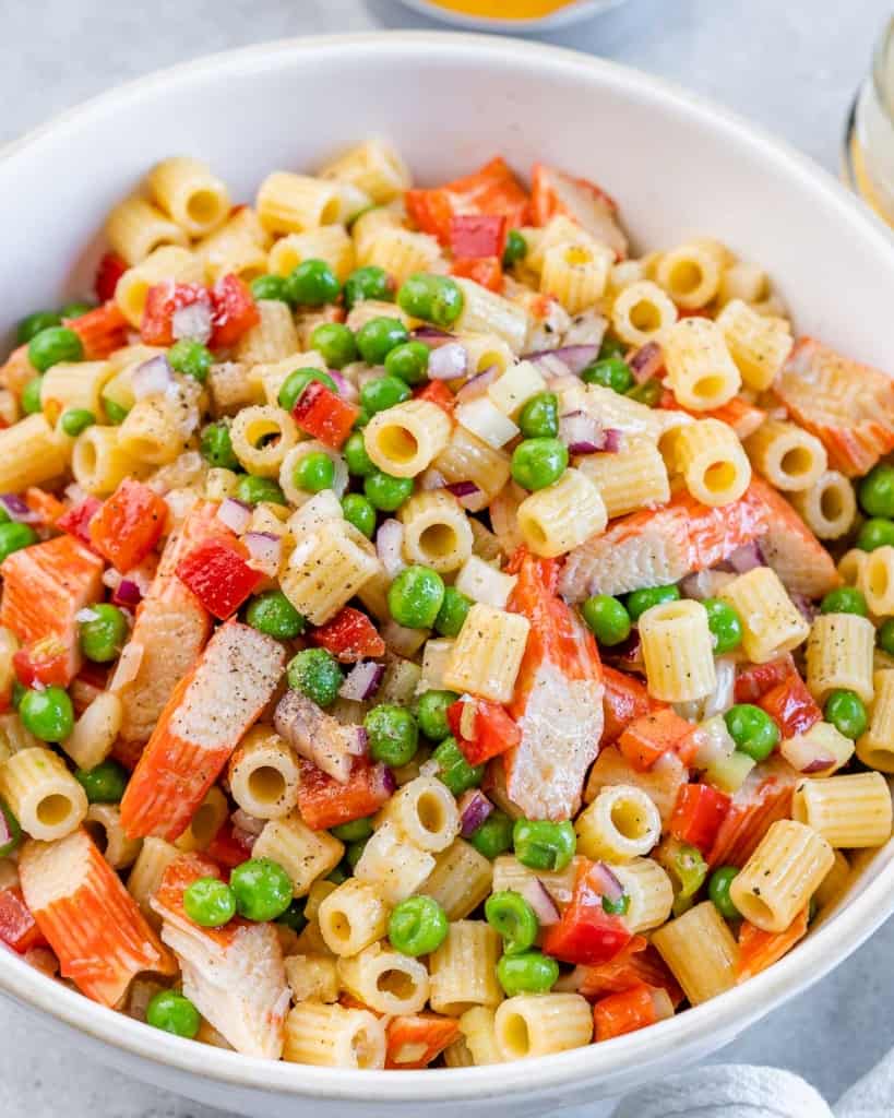 Crab pasta salad in a white bowl.