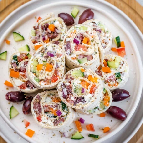 top view greek salad pinwheels on a round white plate