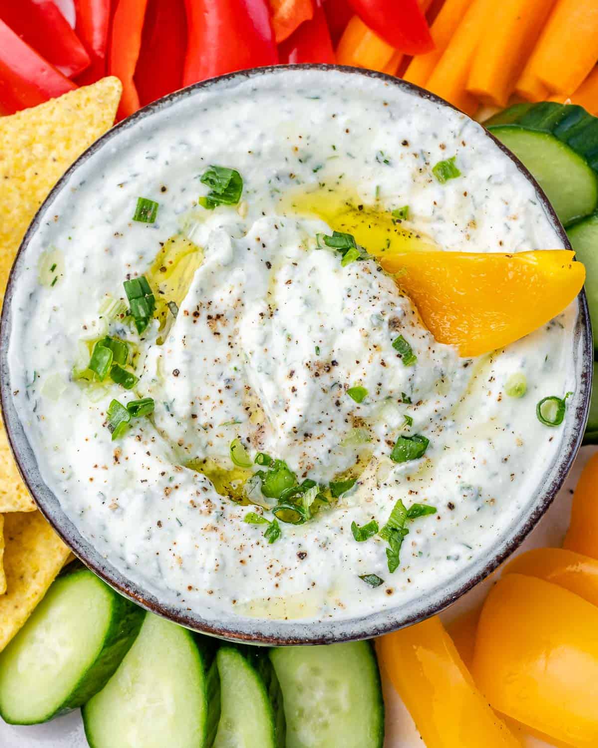 Cottage cheese dip with a slice of yellow bell pepper dipped in.