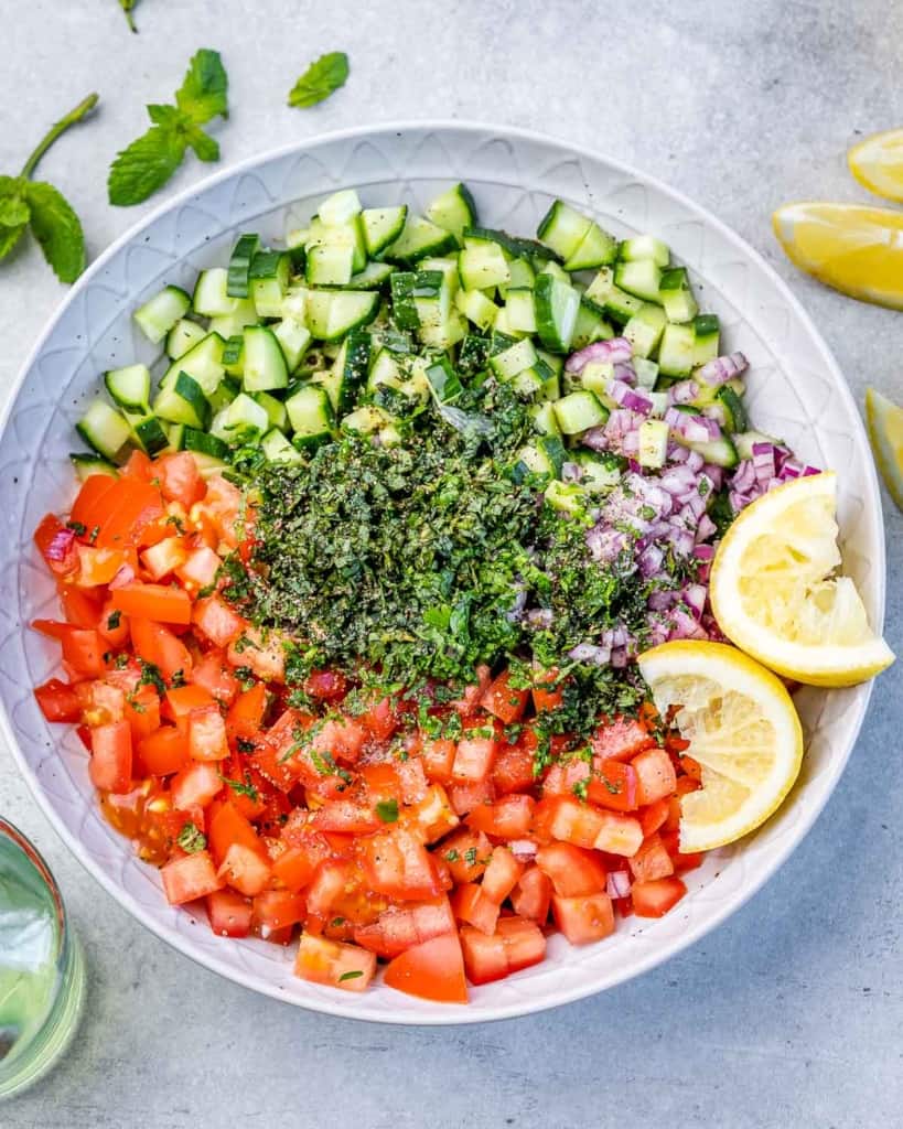 chopped cucumber, tomato, onion, and parsley in a bowl