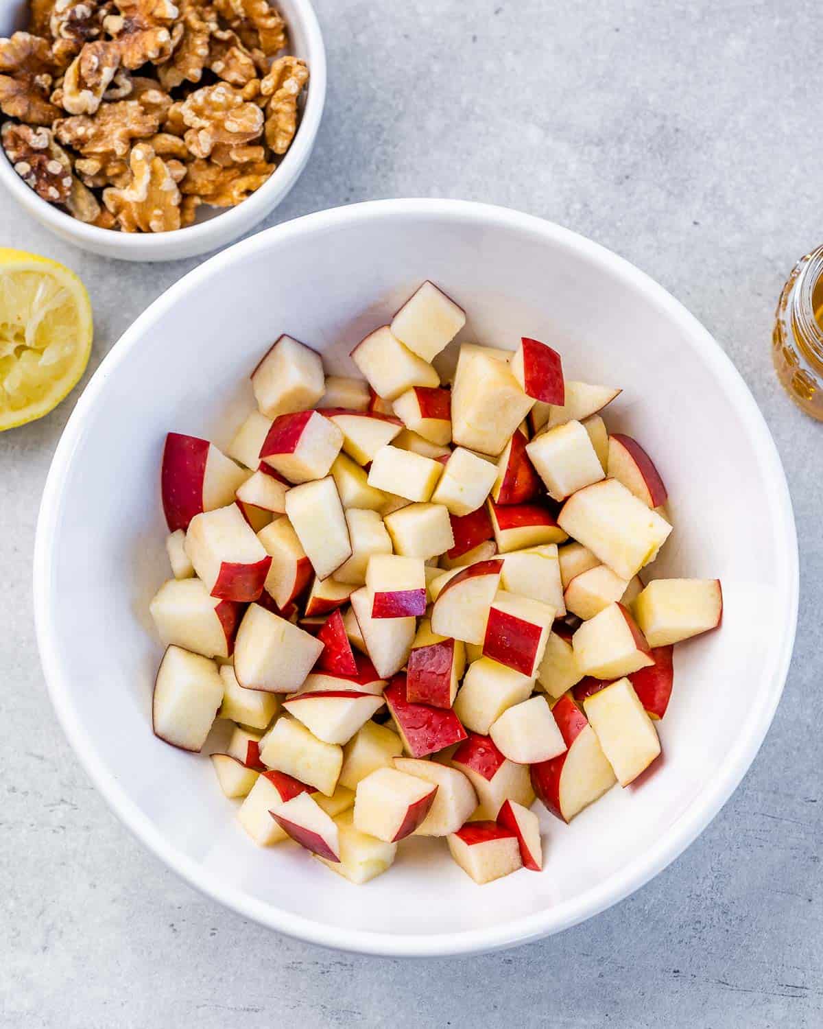 Diced apples in a white bowl.