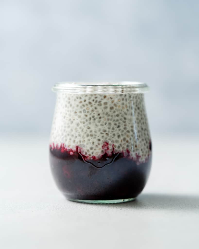 Layering chia pudding over blueberry sauce.