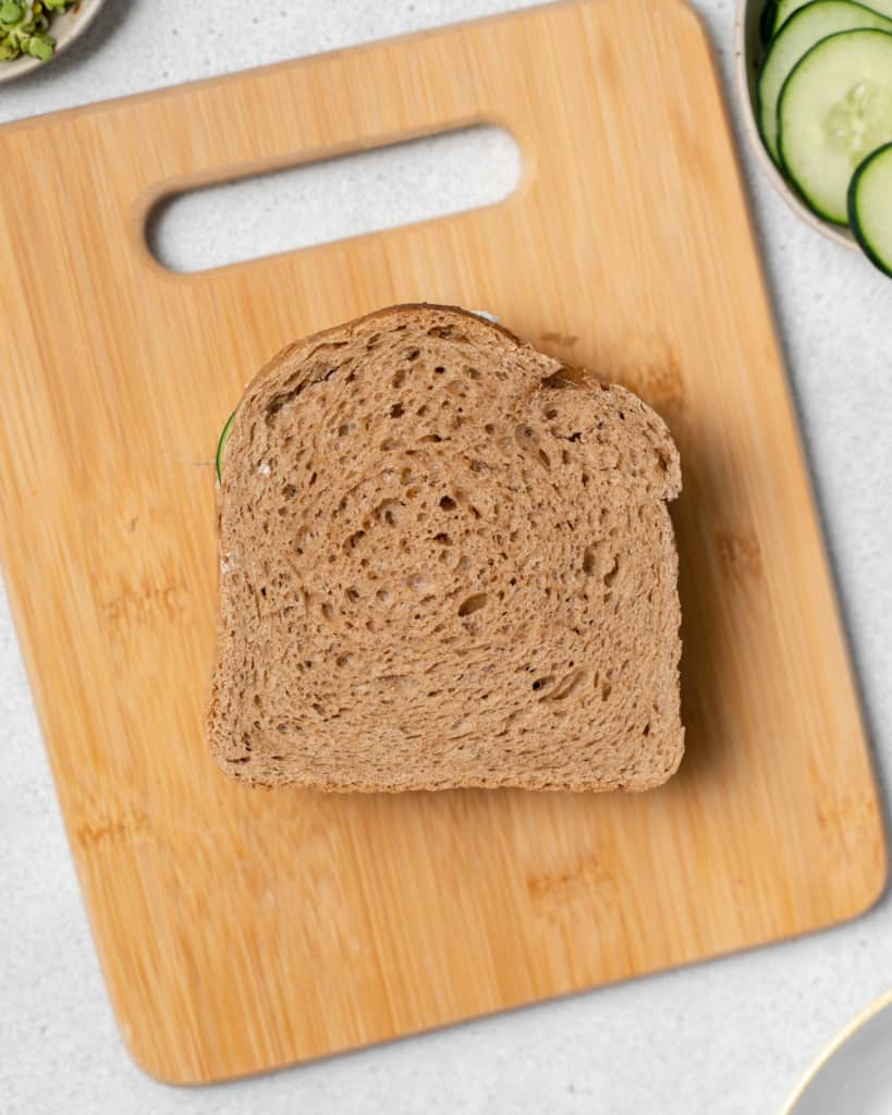 Topping sandwich with a slice of bread.
