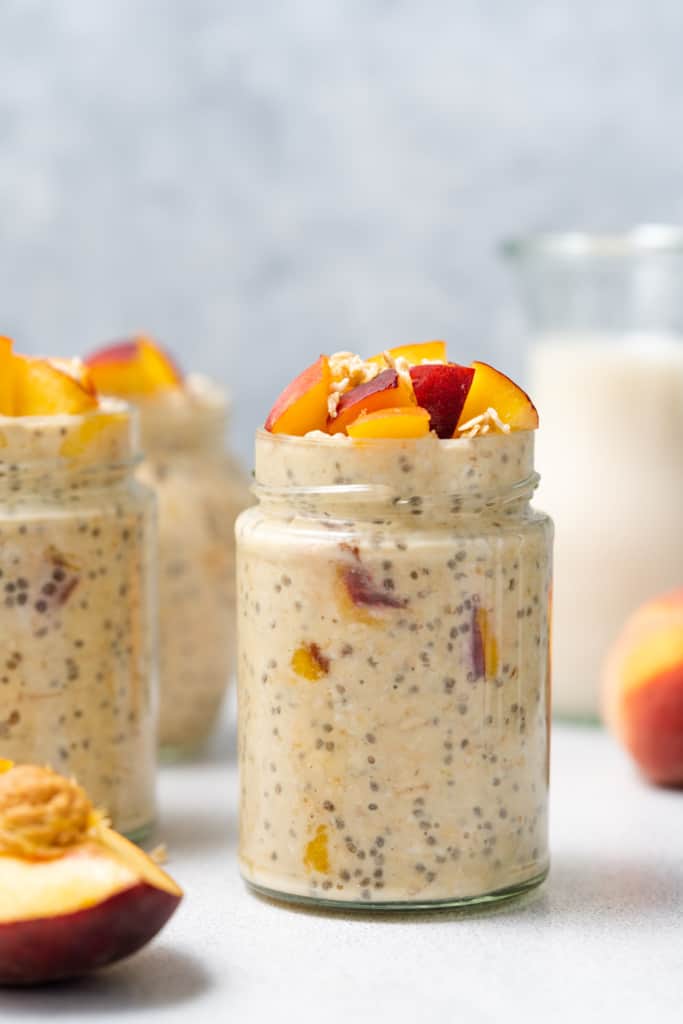Peach overnight oats topped with chopped peaches.