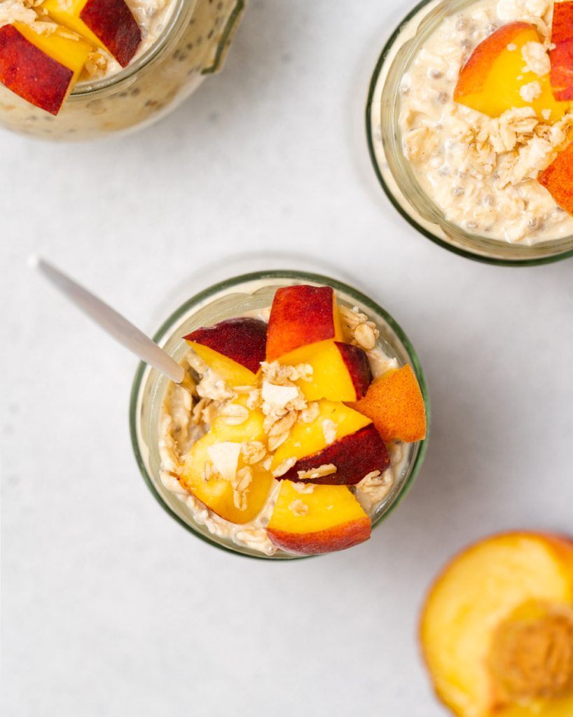 top view jar of overnight oats topped with chopped peaches