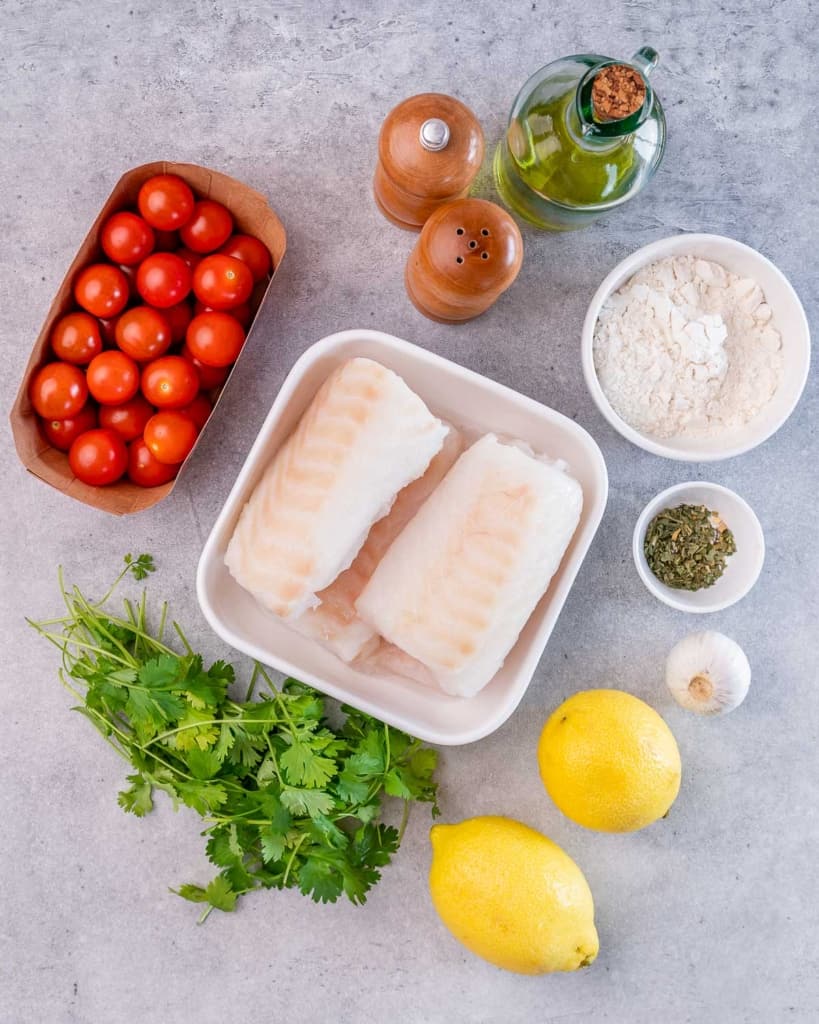 ingredients to make lemon garlic baked cod with tomatoes 