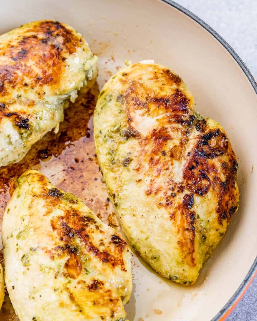 pesto chicken breast sauteed in a pan