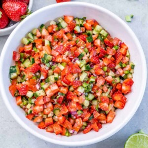 Top view of strawberry salsa in a round white bowl.